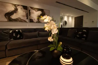 a living room with a couch and a table with flowers at Top Floor Gem: 3BR, Huge Veranda in Nicosia