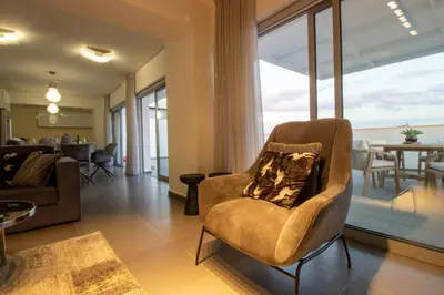 a living room with a couch and a chair at Top Floor Gem: 3BR, Huge Veranda in Nicosia