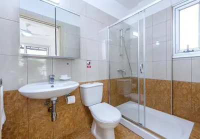 a bathroom with a toilet and a sink and a shower at Konnos Breeze Villa in Protaras