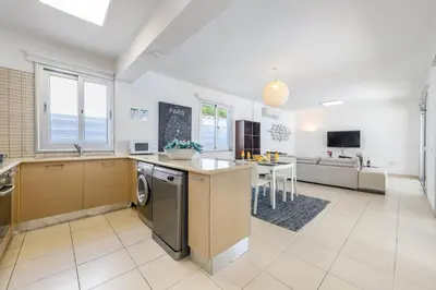 a kitchen and living room with a sink and a dishwasher at Konnos Breeze Villa in Protaras