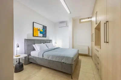 a bedroom with a bed in a white room at Agios Tychon Luxury Villa with Private Pool in Limassol
