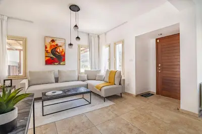 a living room with a couch and a table at Agios Tychon Luxury Villa with Private Pool in Limassol
