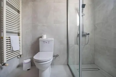 a bathroom with a toilet and a shower at Agios Tychon Luxury Villa with Private Pool in Limassol