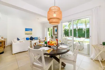 a dining room and living room with a table and chairs at Villa Atlantis in Protaras