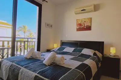 a bedroom with a bed with two pillows on it at Casa Palmera in Paralimni