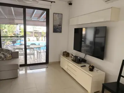 a living room with a large flat screen tv at Casa Palmera in Paralimni