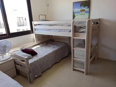 a bedroom with two bunk beds and a bed at Casa Palmera in Paralimni