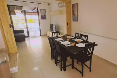 a dining room with a black table and chairs at Casa Palmera in Paralimni