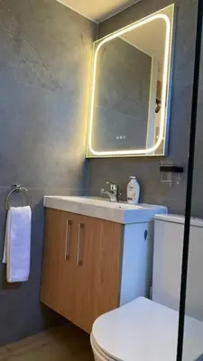a bathroom with a toilet and a sink and a mirror at Beautiful One Bedroom Apartment 100 Meters from the Beach, Recently Renovated in Limassol