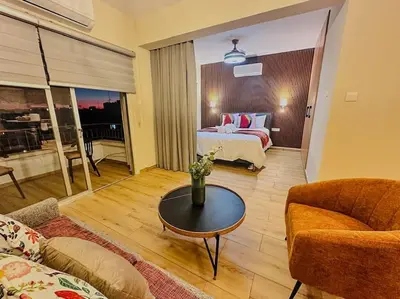 a living room with a bed and a coffee table at Beautiful One Bedroom Apartment 100 Meters from the Beach, Recently Renovated in Limassol