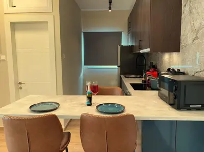a kitchen with a table with two glasses of wine at Beautiful One Bedroom Apartment 100 Meters from the Beach, Recently Renovated in Limassol