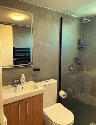 a bathroom with a shower and a toilet and a sink at Beautiful One Bedroom Apartment 100 Meters from the Beach, Recently Renovated in Limassol