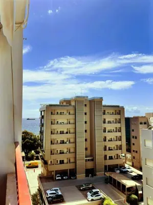 a view of a building with cars parked in a parking lot at Beautiful One Bedroom Apartment 100 Meters from the Beach, Recently Renovated in Limassol