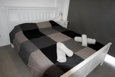a bedroom with a bed with two pillows on it at Haris' Apartment Larnaca in Larnaka