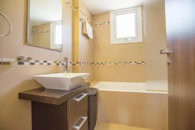 a bathroom with a sink and a bath tub at Mylos Villas in Protaras