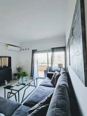 a living room with a blue couch and a table at Diana Apartment in Limassol