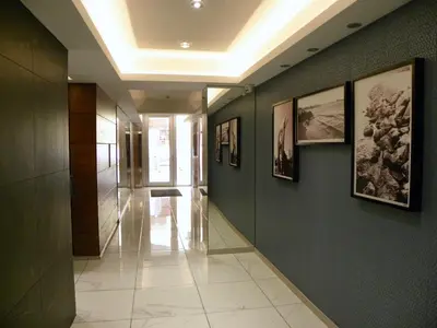 a hallway with pictures on the walls of a building at Diana Apartment in Limassol