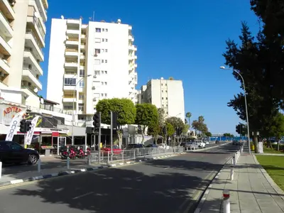 an empty street in a city with tall buildings at Diana Apartment in Limassol