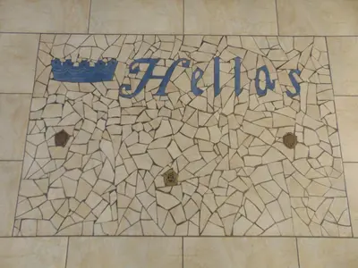 a tile floor with the wordiasis written on it at Hellas Hotel in Kakopetria