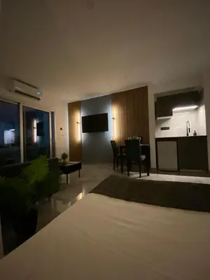 a living room with a bed and a dining room at Nissi Avenue Studios in Ayia Napa