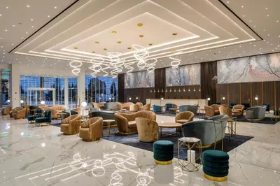 a lobby with chairs and tables in a building at The HEALTHY Stay-Padel, Pool&Fitness in Ayia Napa