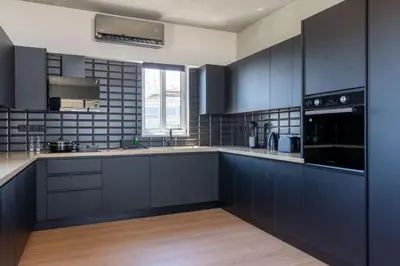 a kitchen with blue cabinets and a stove top oven at The Penthouse - 3BR Seaview with Private Pool in Larnaca in Larnaka