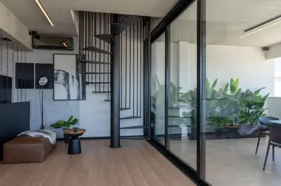 a living room with sliding glass doors and plants at The Penthouse - 3BR Seaview with Private Pool in Larnaca in Larnaka