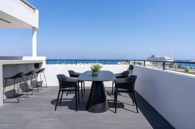 a table and chairs on a balcony with a view of the ocean at The Penthouse - 3BR Seaview with Private Pool in Larnaca in Larnaka