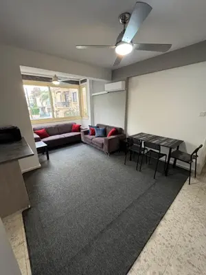 a living room with a couch and a table at Georges 2 Bedroom Apartment in Limassol