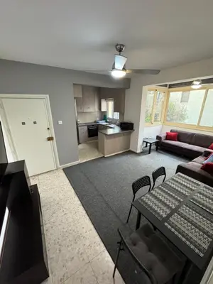 a living room with a couch and a table at Georges 2 Bedroom Apartment in Limassol