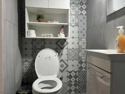 a bathroom with a toilet and a sink at 1 room apartment on the 1st line in Limassol