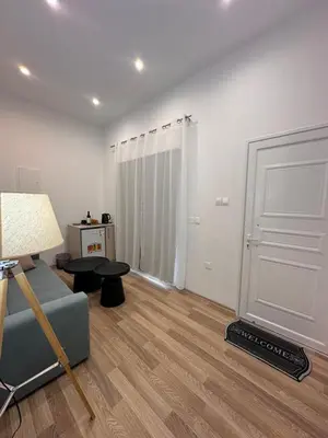 a living room with a couch and a door at Joanna's Rooms in Kalopanayiotis