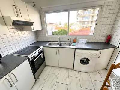a kitchen with a sink and a washing machine at Samos City Center, 2BR Sleeps 4 in Limassol