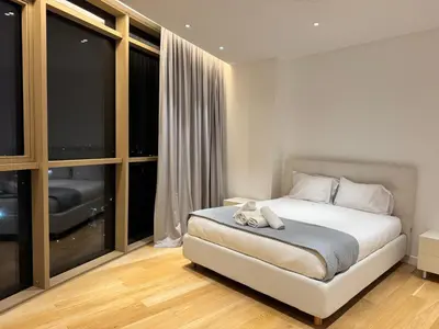 a bedroom with a bed and a large window at WealthyStays 360 Luxury Residence in Nicosia