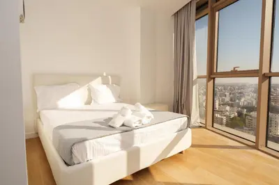 a white bed in a room with a large window at WealthyStays 360 Luxury Residence in Nicosia