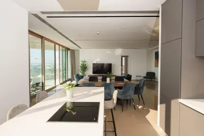a kitchen and living room with a table and chairs at WealthyStays 360 Luxury Residence in Nicosia