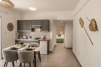 a kitchen and dining room with a table and chairs at Somantonia apartments in Protaras