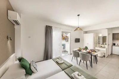 a living room with a couch and a dining room at Somantonia apartments in Protaras