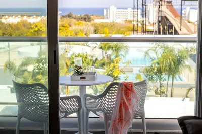 a table and two chairs in front of a window at Somantonia apartments in Protaras