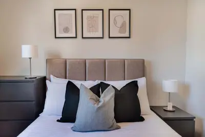 a bedroom with a bed with black and white pillows at Phaedrus Living Evergreen Nicosia City Residence in Nicosia
