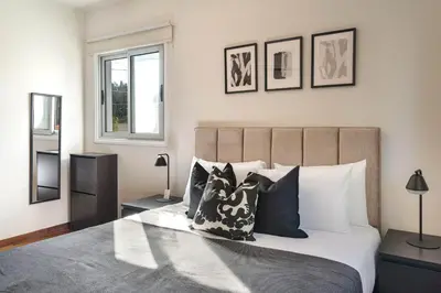 a bedroom with a large bed with pillows at Phaedrus Living Evergreen Nicosia City Residence in Nicosia