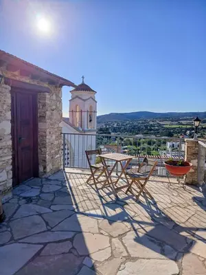 a patio with a table and chairs on a building at Skarinou Panorama Room in Skarinou