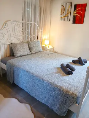 a bedroom with a bed with two slippers on it at Skarinou Panorama Room in Skarinou