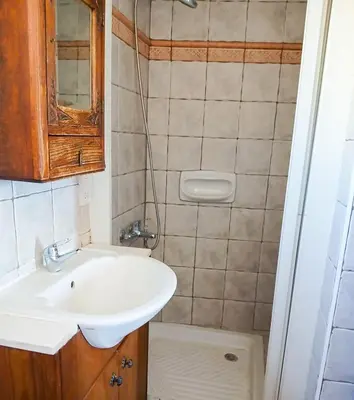 a small bathroom with a sink and a toilet at Skarinou Panorama Room in Skarinou