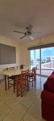 a living room with a table and chairs and a chalkboard at Parlena Latsia in Laxia
