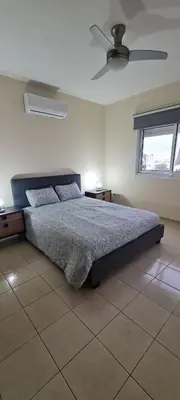 a bedroom with a bed and a ceiling fan at Parlena Latsia in Laxia