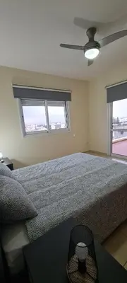 a bedroom with a large bed and two windows at Parlena Latsia in Laxia