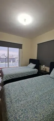 a hotel room with two beds and a large window at Parlena Latsia in Laxia
