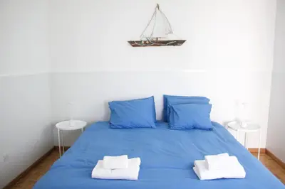 a blue bed with two towels on top of it at Freshness Modern 2 Bedroom Apartment with Balcony & Stunning Sea View in Central Limassol in Limassol