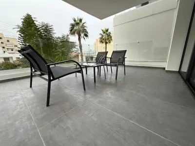 a patio with chairs and a table on a balcony at Glabur Stays - Nicosia Elite 2BDR in Nicosia